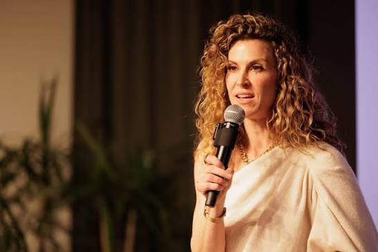 Joanna Horton-McPherson on stage speaking at a leadership event.