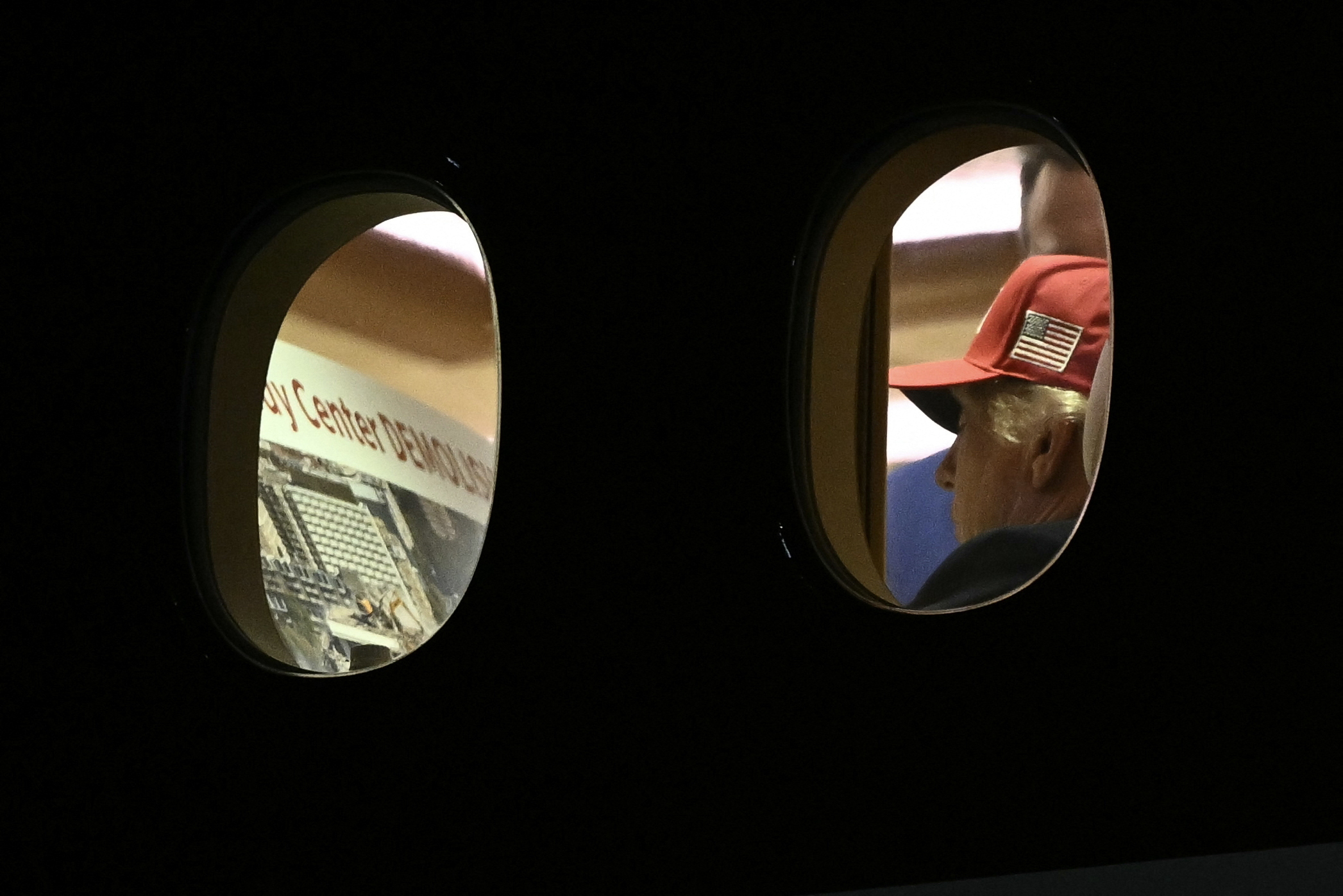 President Donald Trump is seen aboard Air Force One looking at a large Kennedy Center printout after landing in Maryland on Wednesday.