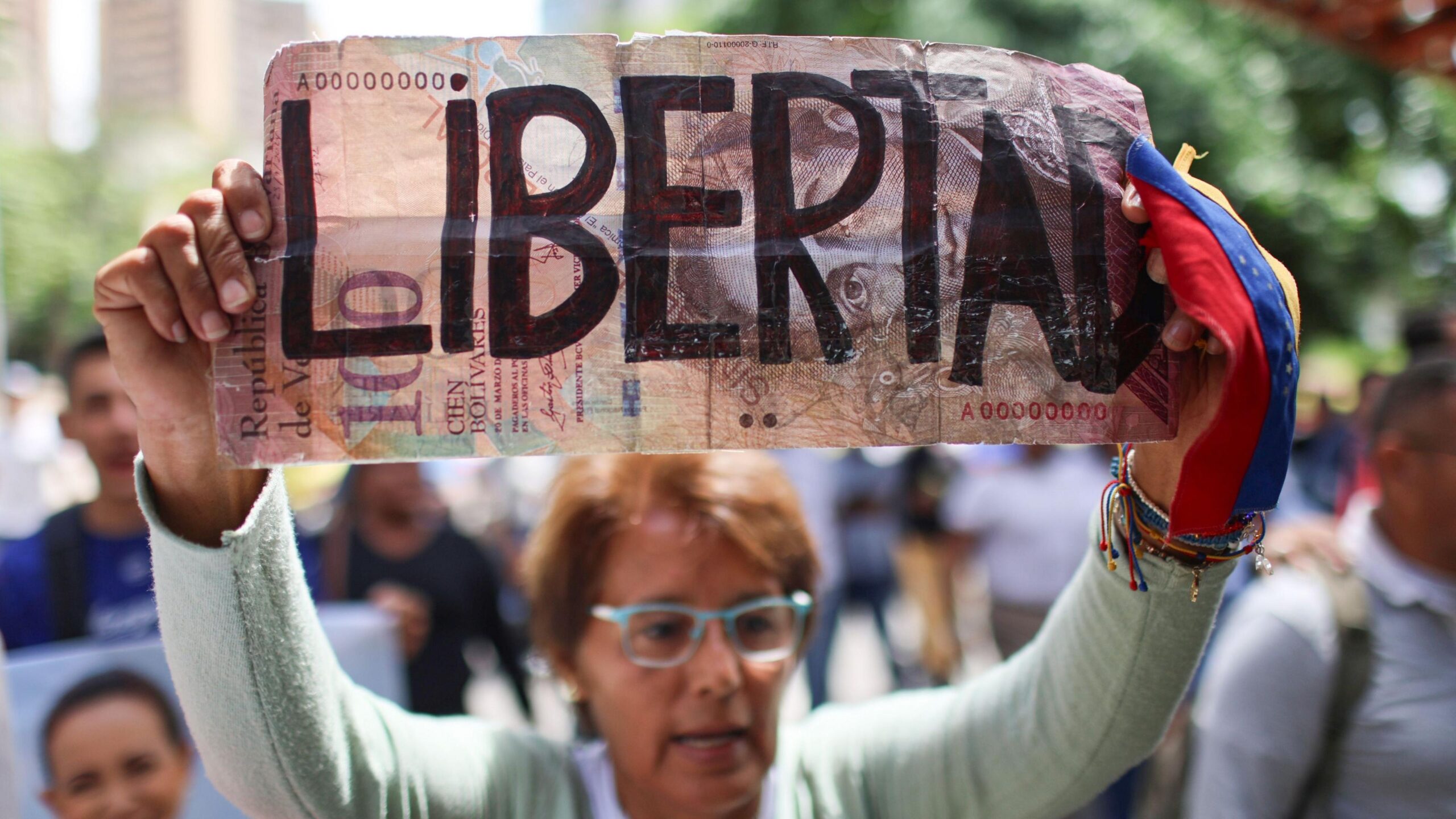 A woman holds a sign during a demonstration calling for the return of opposition leader Maria Corina Machado and free elections in Venezuela, in Caracas.