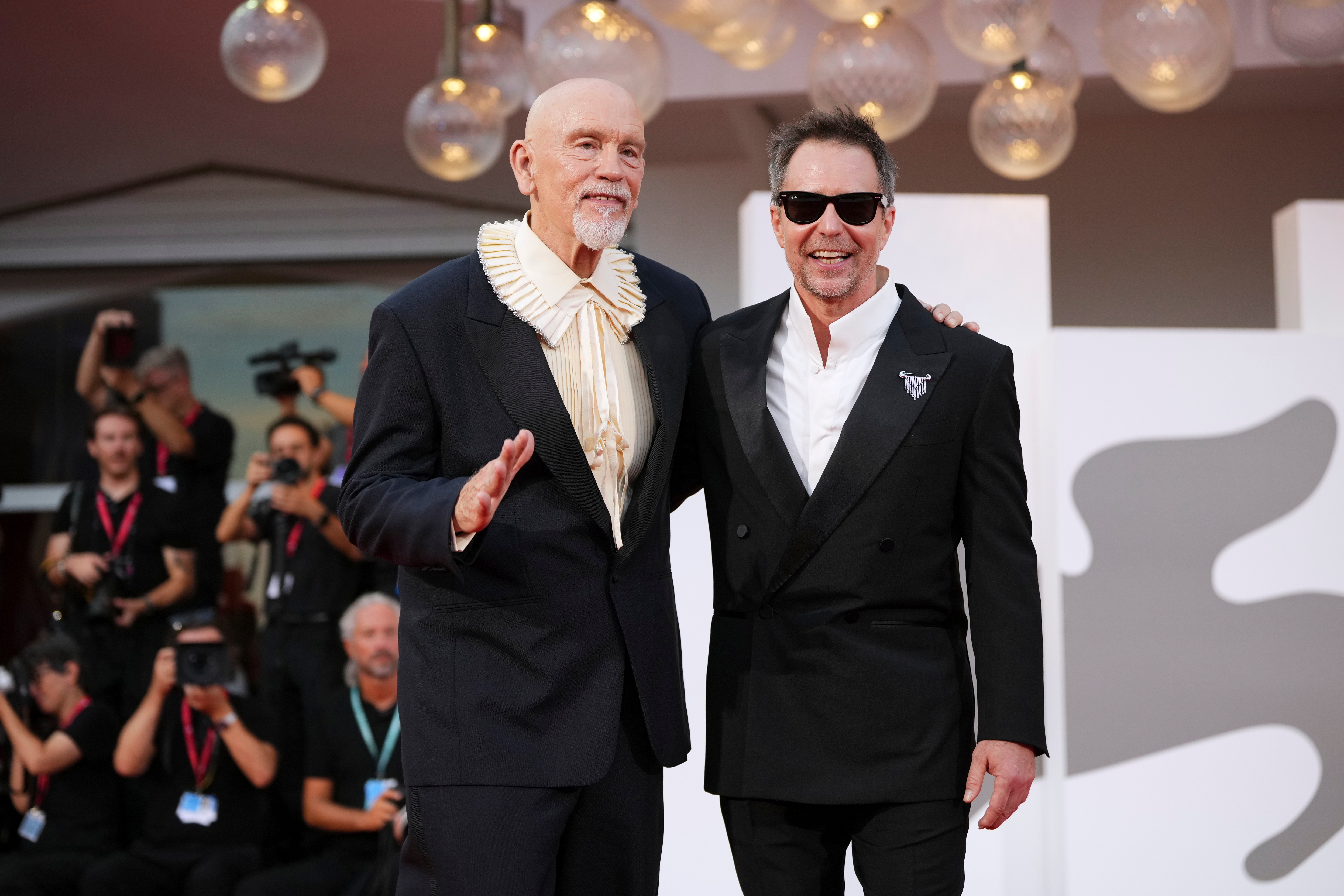 John Malkovich, left, and Sam Rockwell pose for photographers at the red carpet for the film