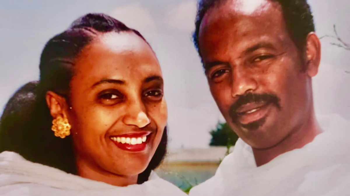 Aster Yohannes and Petros Solomon smiling and dressed in white