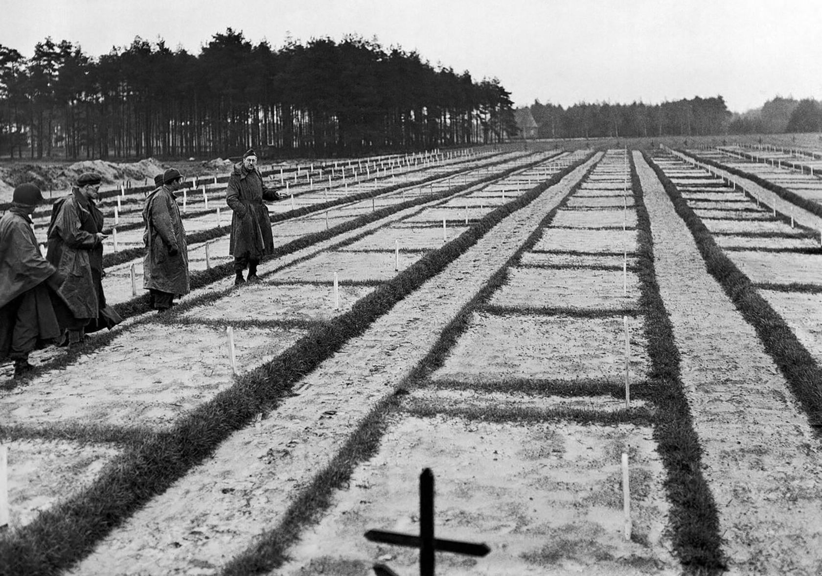 A black and white pictured showing men in a graveyard