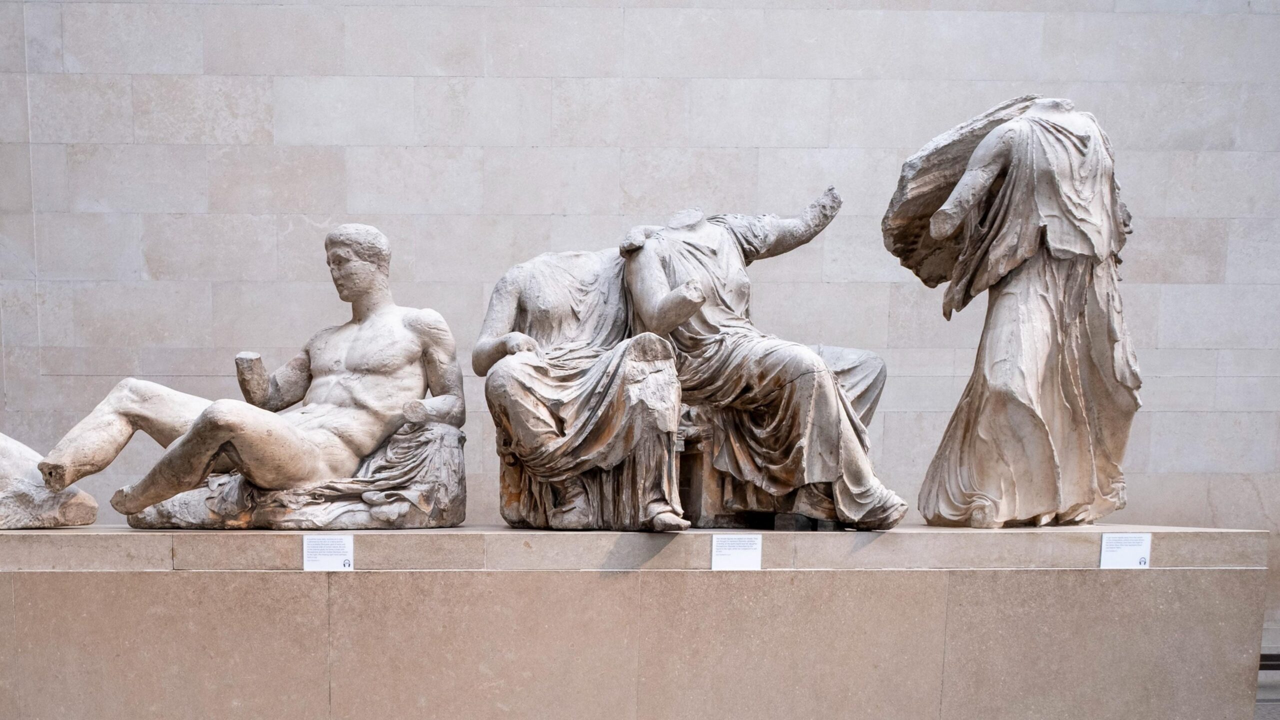 Some of the Parthenon sculptures in the British Museum. The sculptures are damaged, with some missing limbs and heads