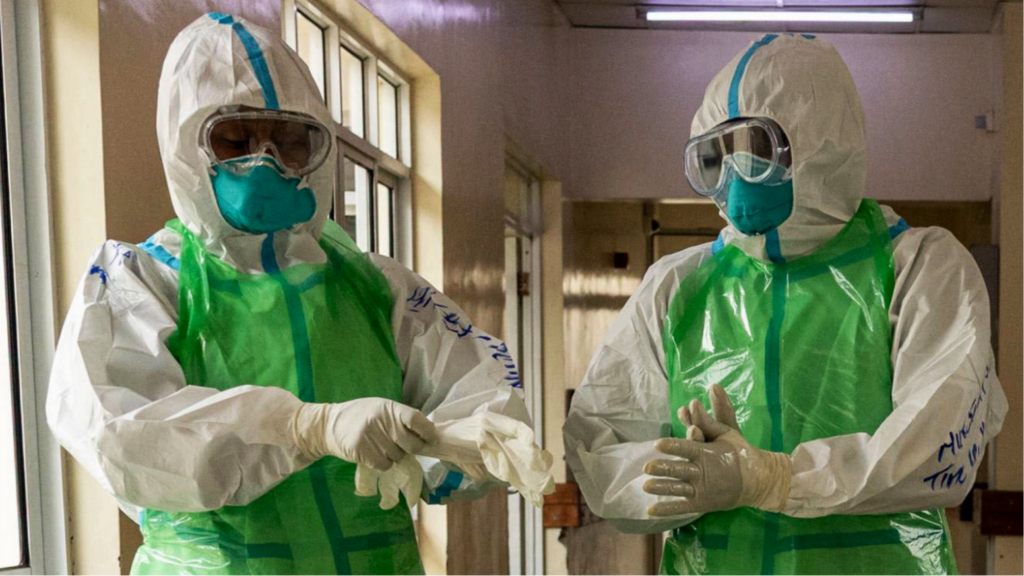 Two nurses in white and green PPE prepare to receive an Ebola patient during a simulation exercise at the special isolation ward the the Kenyatta National hospital in Nairobi on 12 June 2026.