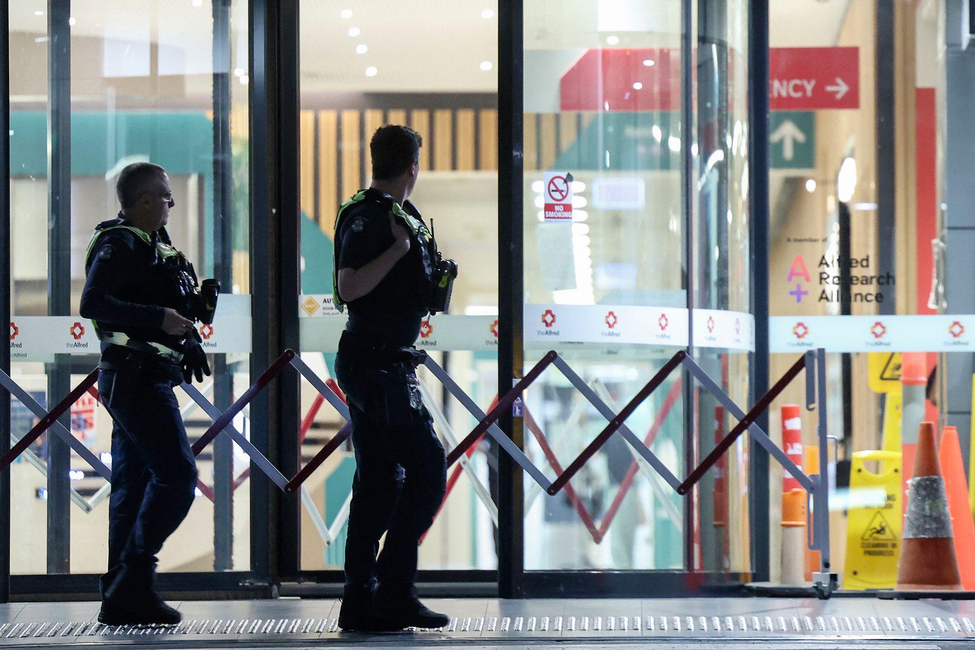 Police are seen outside Alfred Hospital in Melbourne, where Australian independent lawmaker Helen Haines was airlifted to for treatment with critical injuries after being struck by a car outside her office in Wangaratta