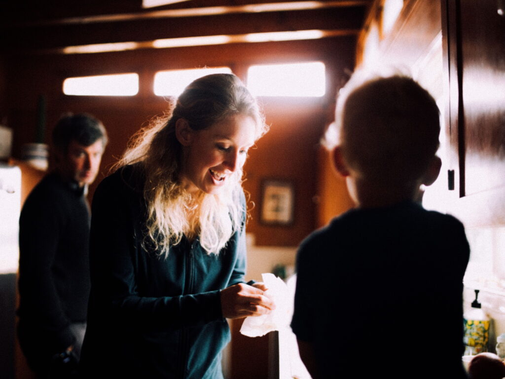Elizabeth Holmes with her child as Nathan Fielder looks on.