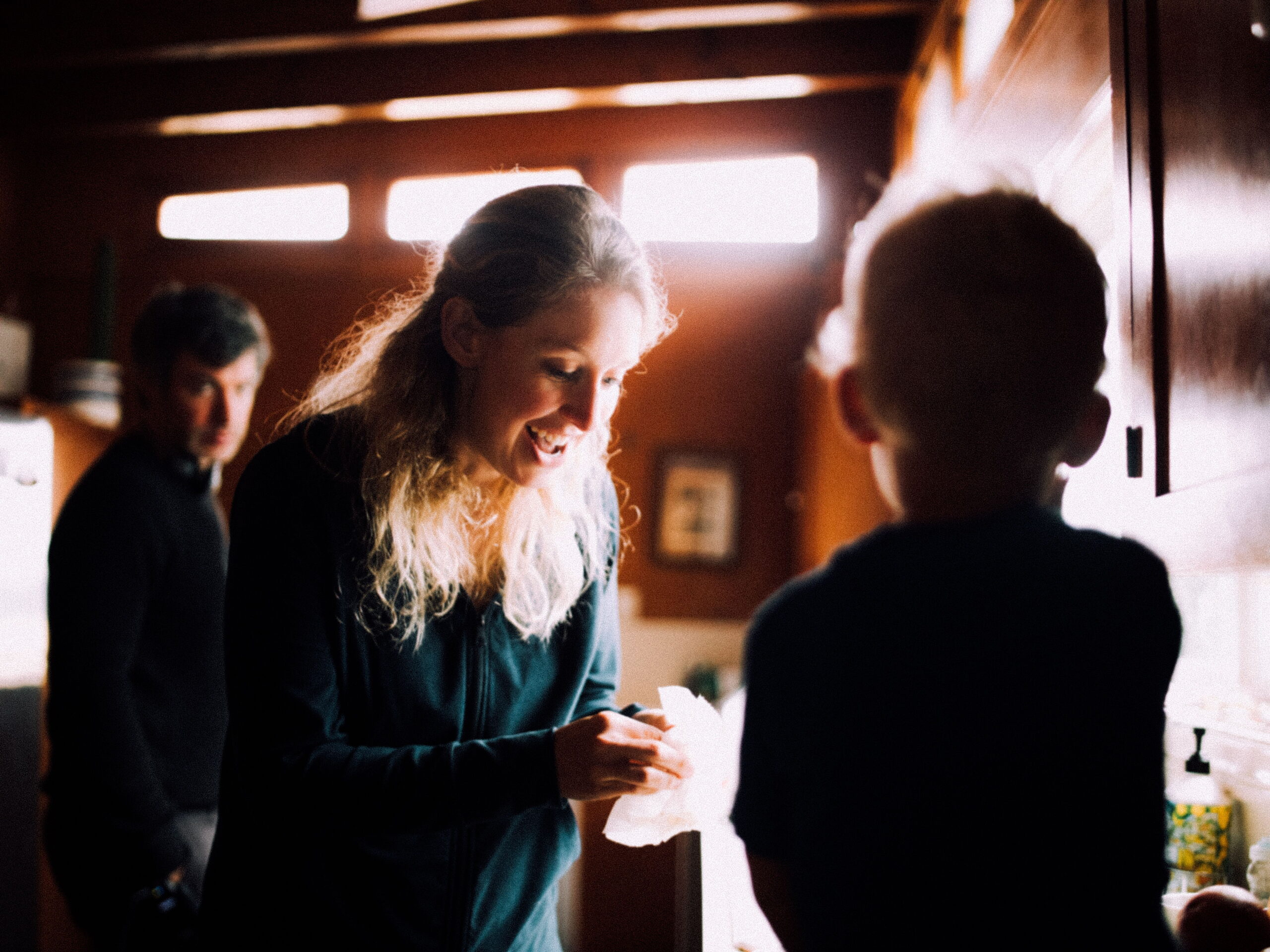 Elizabeth Holmes with her child as Nathan Fielder looks on.