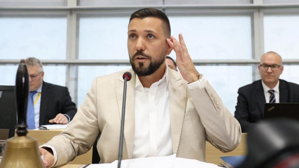 Saxony-Anhalt's newly elected regional parliament speaker Tobias Rausch sits in his chair during the parliament's constitutional session in Magdeburg