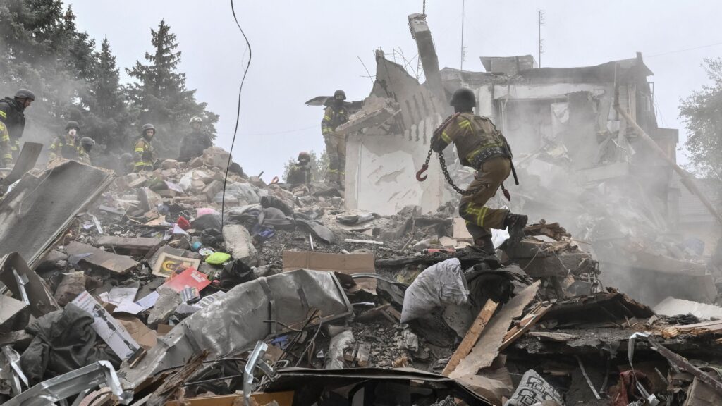 Rescuers work at a site of an apartment building damaged during a Russian air strike, amid Russia's attack on Ukraine, in Zaporizhzhia,