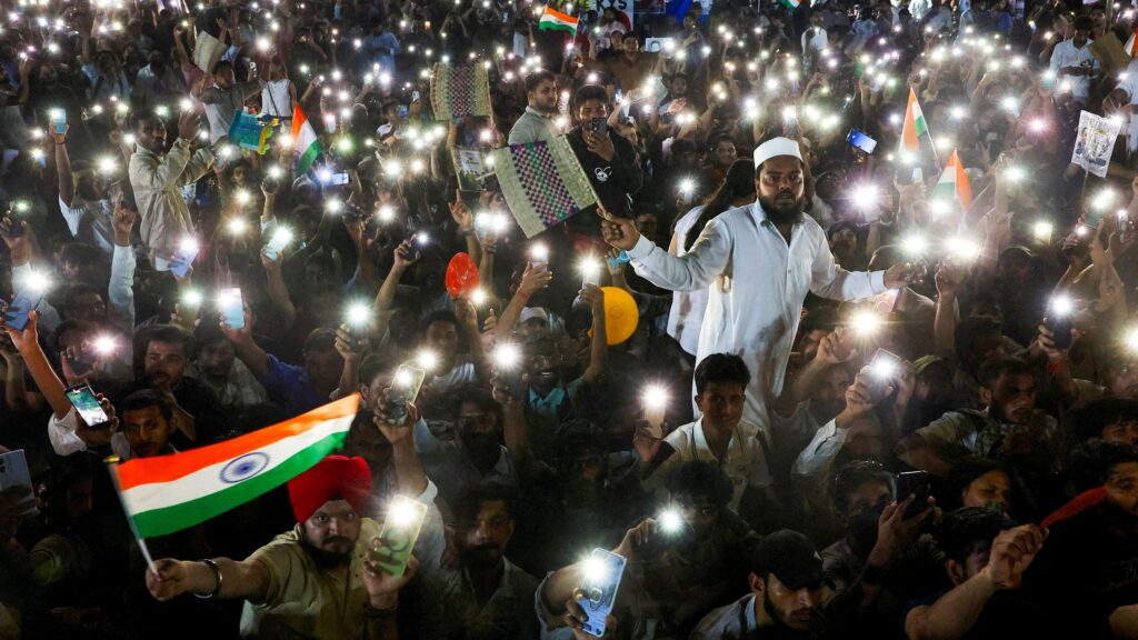 Supporters of the Cockroach Janta Party chant slogans and wave their mobile phones with their flashlights on as they gather after the Indian education reformer Sonam Wangchuk, who had been on a hunger strike, was taken to a hospital by authorities at Jantar Mantar in New Delhi on July 19, 2026.