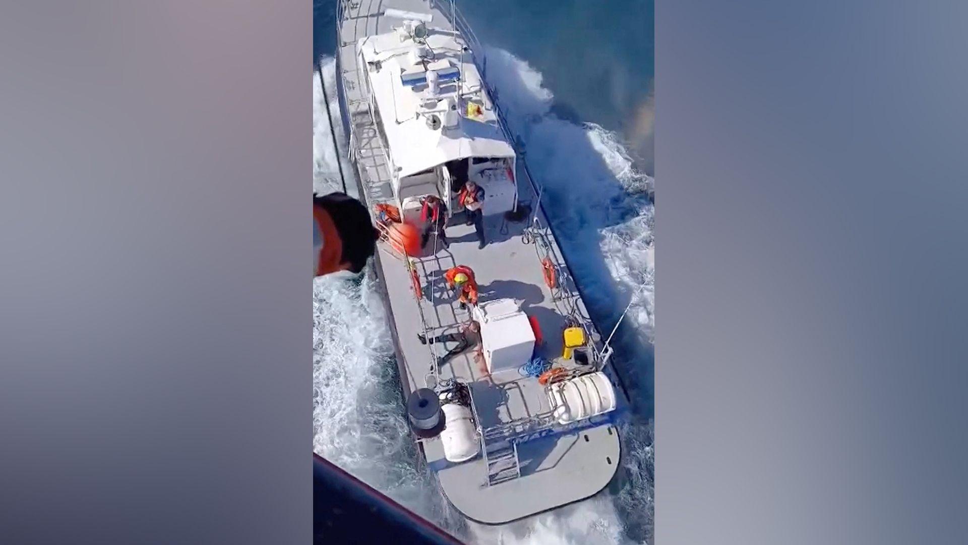 A rescue operation following a fire on a vessel outside Romania's territorial waters, in which two people died and others were rescued, in this screengrab obtained from a handout video released on October 5, 2026.