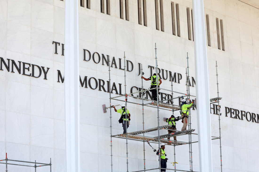 Workers stand on scaffolding outside the Kennedy Center.